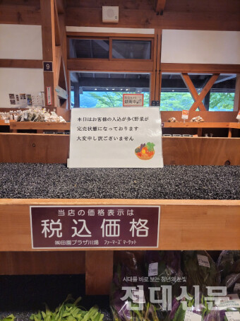 파머스마켓 가판대에 적힌 “오늘은 손님이 많이 와 야채가 다 팔렸습니다. 대단히 죄송합니다.” 문구.