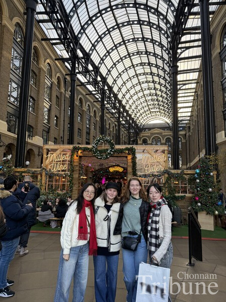 Lee Younny and her friends pose for a picture at the London Christmas market.